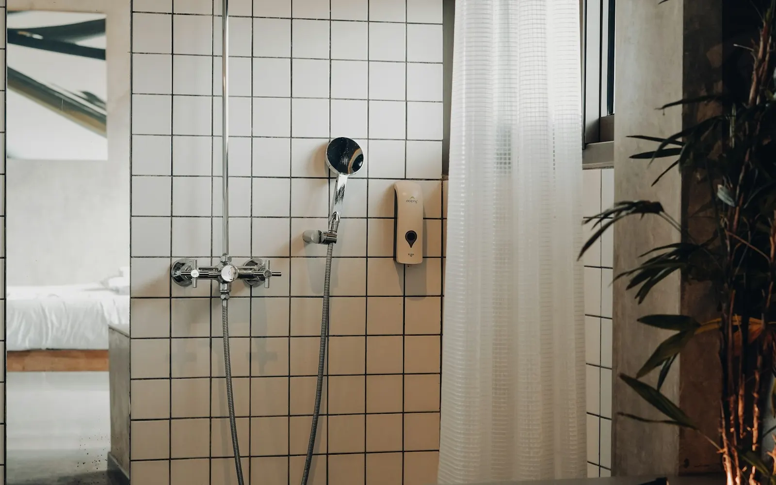 Bathroom shower with tiled walls and a glass enclosure.